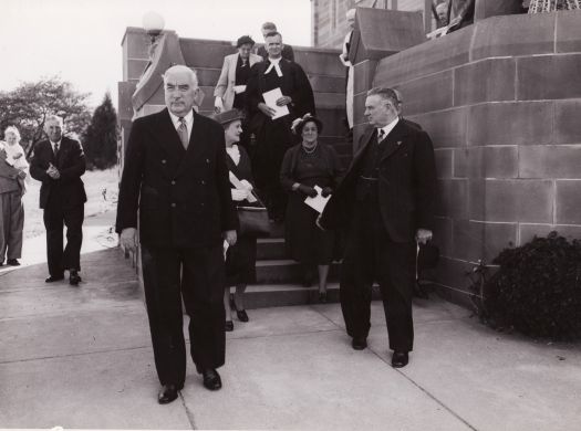 Prime Minister Robert Menzies, Dame Pattie Menzies, Reverend Hector Harrison on stairs at St Andrew's Presbyterian Church in Forrest with Mrs Harrison behind.