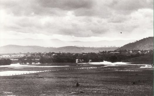 Molonglo River in flood looking across paddocks to Acton