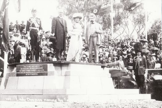 Lady Denman naming "Canberra" with Lord Denman, Andrew Fisher, King O'Malley standing on a platform on top of the commemoration stone