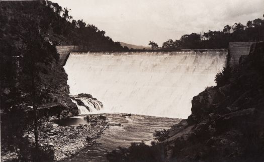 The first Cotter Dam showing water flowing down the wall into the Cotter River.