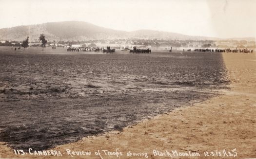 Distant view of the review of troops during the naming of Canberra ceremony in March 1913. View is from the south looking towards Black Mountain.
