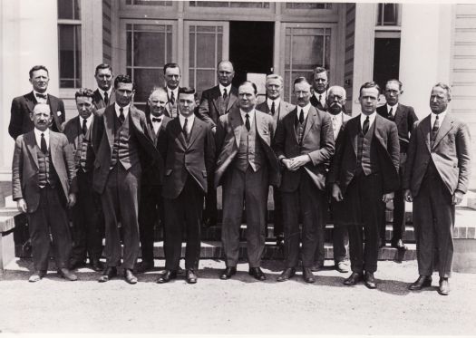 Senior officers of the Federal Capital Commission c1926. 
Back row: (l to r) Unknown, W. Farrow, Unknown, H.R. Waterman, P.L. Sheaffe, Unknown. 
Middle row: W. Butler, C. Francis, T.C.G. Weston, A.W. Edwards.
Front row: Unknown, W.N. Rowse, C.S. Daley, J.H. Butters, H.M. Rolland, W.E. Potts, J.C. Brackenreg.
