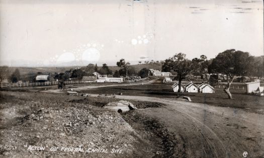 View looking down road towards Acton House. Workmen's tents and the Bachelor Quarters are visible.
