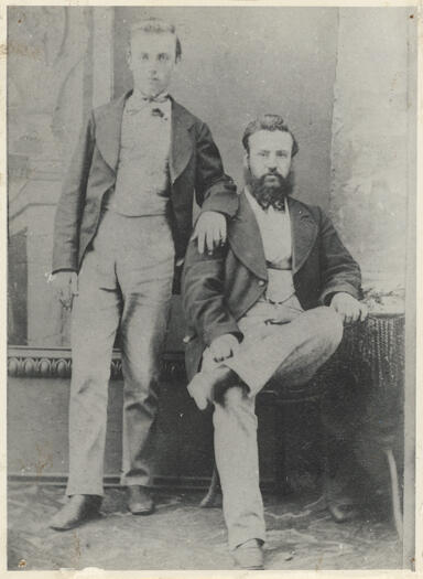 Portrait. Edwin H Land on left (standing) and Louis Smith on right (sitting). See notes.