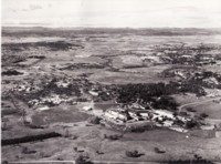 Aerial view of the Australian National University from near Black Mountain, looking east. Shows the Molonglo River, Sullivans Creek and the John Curtin School of Medical Research. The dome of the Academy of Science can be seen as can the Acton Racecourse on the right foreground.