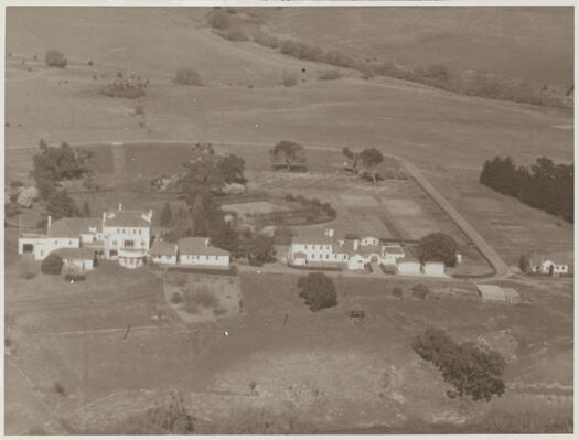 Aerial view of the Governor General's residence at Yarralumla looking west, showing outbuildings, Yarralumla Creek in the distance and the Molonglo River in the foreground.