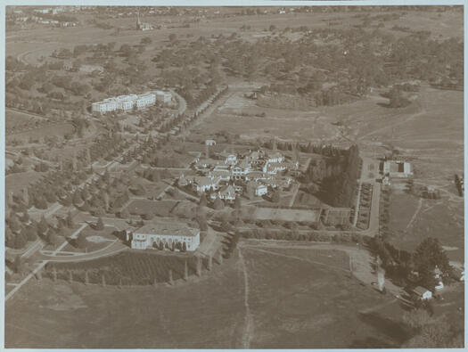 Albert Hall and Hotel Canberra, Yarralumla, from the air. Also visible are West Block and the golf club with Commonwealth Avenue in the middle foreground and St John's Church, Reid, in the distance.