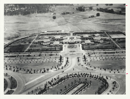 Aerial view of the Hotel Canberra with the Molonglo River in the distance, Westlake to the left, Commonwealth Avenue in the foreground with Langton Crescent and small trees growing where the Treasury Building now stands.