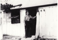 House built by Thomas Tong showing his son Jack in the doorway