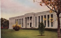 Front view of Institute of Anatomy, McCoy Cct, Acton showing the lawns and shrubs. Text on the back: Autumn colour of leaves. One of Canberra's beautiful buildings on severely classical lines. Houses more unique exhibits which have attracted the attention of scientist and scholars throughout the world.