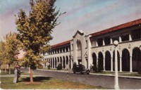 Melbourne Building, Civic Centre. Text on back of postcard: Showing Spanish (sic) type of architecture, the colonnades make an impressive sight. This is one of the shopping and main banking centres.

A 1940s style car is parked in front of the building, probably on Northbourne Avenue.