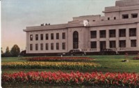 View of the eastern end of Parliament House. Text on the back: The tulip beds. When in bloom about November, these flowers make a most wonderful sight in front of Parliament House; the original bulbs were imported from Holland.