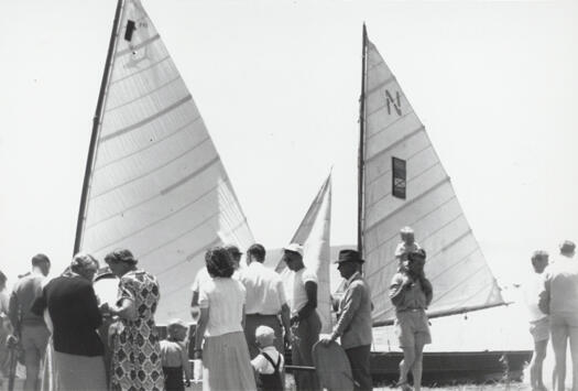 Lake George Sailing Club regatta, people inspecting three yachts.