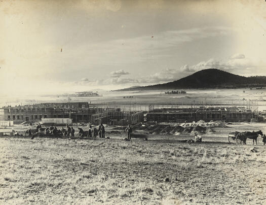 Early stages of the construction of Parliament House with Black Mountain in the background