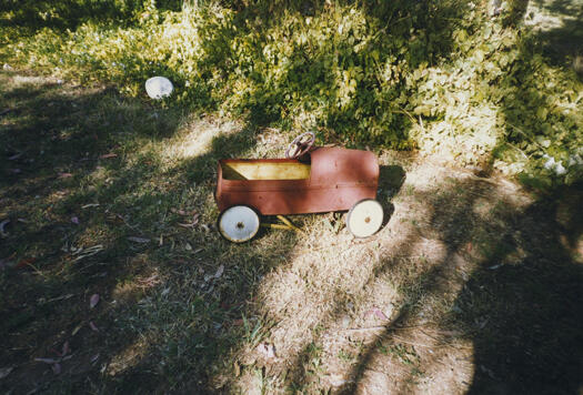 CDHS excursion to Tuggeranong showing a toy car on the lawn at the old schoolhouse