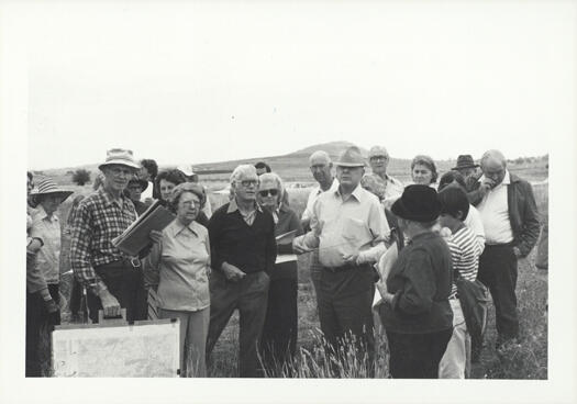 CDHS excursion to Lanyon and Tuggeranong. One of the group is using a map pinned to a board and talking to the group.