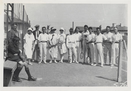 Tennis club. Mixed players with schoolboy.