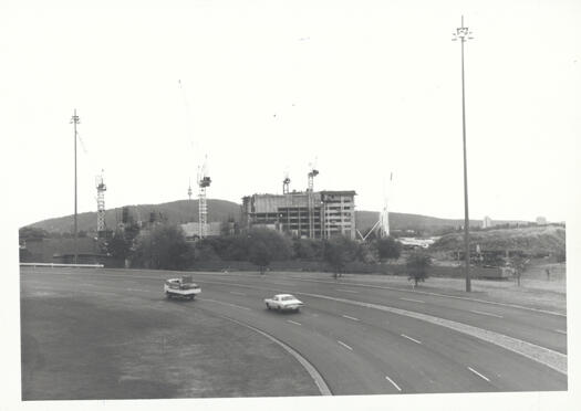 National Gallery and High Court under construction. View taken from Kings Avenue looking past Bowen Drive showing two vehicles on the road.