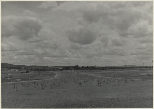 View of Parkes Way looking west from Kings Avenue towards Civic. Blundells Cottage is visible mid left.