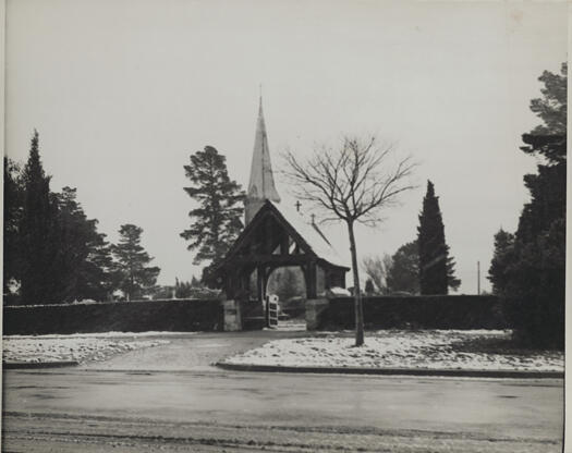 St John's Church showing the lychgate in front of the church covered in snow.