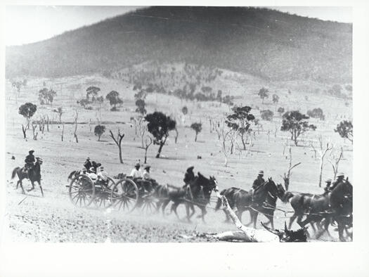 Royal Military College, Duntroon. Manoeuvres. Horse drawn artillery piece with Mount Ainslie in the background.