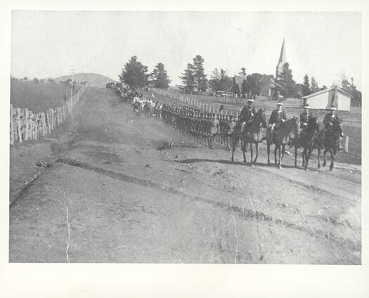 Funeral of Major General Sir William Throsby Bridges, KCB, CMG. Shows the cortege moving north along what is now Anzac Avenue, with St. John's Church in the background.
