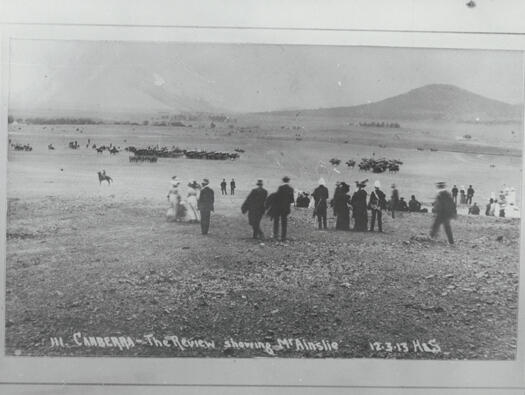 Troop review, Commencement Ceremony, Canberra foundation day 12 March 1913. Text '111 Canberra - the review showing Mt Ainslie H&S' is along the bottom.