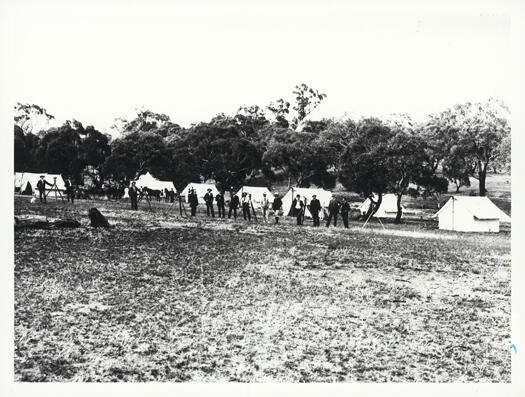 First survey, surveyors camp showing a line of unidentified men.