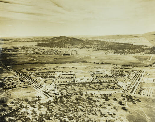 Aerial view over the Parliamentary triangle. Old Parliament House is in the centre. Also shown are West Block, East Block, the Albert Hall, the Molonglo River flowing the midle of the picture, St. John's Church and Black Mountain.