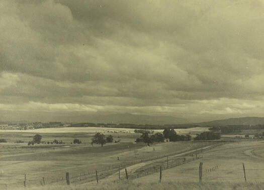 Corkhill's Dairy in the middle of the photo with Mt. Stromlo in the distance.