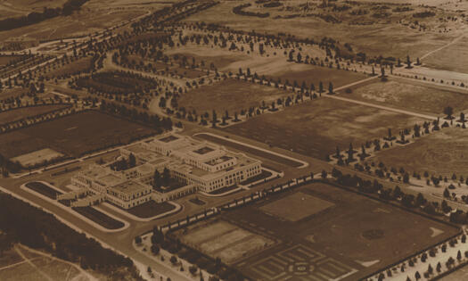 Aerial view of Parliament House from the south with the Albert Hall at top left.