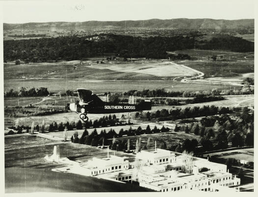 'Southern Cross' bi-plane flying over Parliament House. According to The Canberra Times (22 May 1945) it was a test flight prior to the plane being used in a movie about Charles Kingsford-Smith.