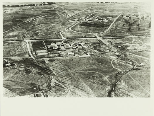 An aerial view showing the Hotel Canberra and partially constructed Parliament House, taken before the construction of West Block and the Albert Hall.