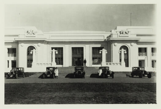 Opening of Parliament House. Front view showing five government cars and drivers lined up.