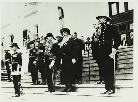 Governor General, Sir Isaac Isaacs, taking the salute at Parliament House with Lady Isaacs