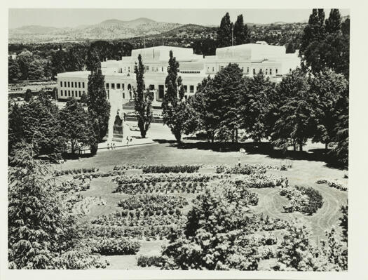 An aerial view of Parliament House showing the King George V statue and rose gardens.