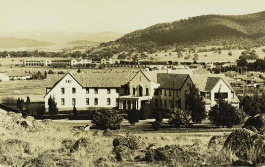 Shows the front of the Hotel Ainslie from Limestone Avenue, with the Sydney Building visible in the rear as is part of Black Mountain.