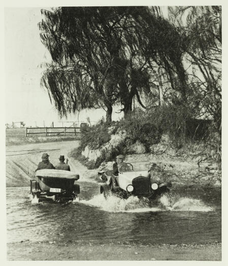 Two cars passing each other on a crossing over the Molonglo River