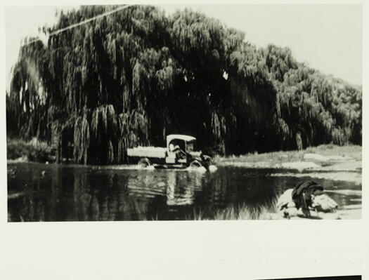 Truck crossing the Molonglo River with willow trees in the background. Possibly Scott's Crossing.