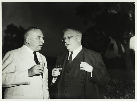 Dr H.V. Evatt at the American Embassy talking to an unidentified person.