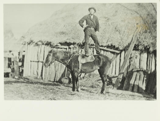 Richard Southwell of Parkwood sitting on his horse in front of a slab building.