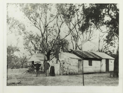 Duntroon home built by Ned Arneson, a Norweigan plumber, in 1914. The photo shows four people and a bicycle in front of the house.
