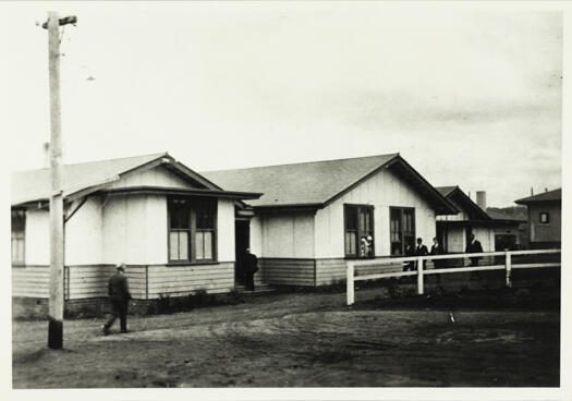 Printers Quarters in Eastlake, dining and recreation block. A man can be seen moving about in front of the building.