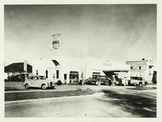 Genge's Garage, 9 Lonsdale Street, Braddon. Shows a side and front view and signs indicating Austin cars and Shell petrol are for sale.