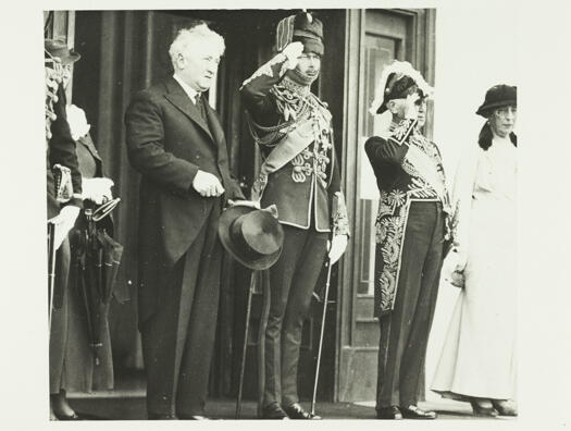 Royal visit to Government House, Yarralumla. The Duke of Gloucester taking the salute. Onthe left hand side is Major Curtis and on the right is the Governor General, Sir Isaac Isaacs and his wife, Lady Isaacs.