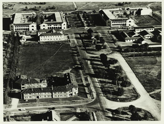 Northbourne Avenue at Civic showing the Hotel Civic opposite the Sydney Building with the Melbourne Building and the Myuna Flats also visible.