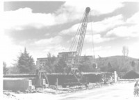 Kings Avenue Bridge under construction showing the southern end. Shows a crane pouring concrete for pre-stressed concrete beams.