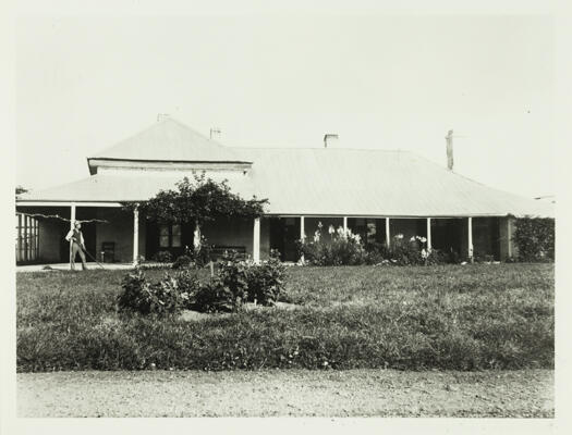 Acton House with gardener out front