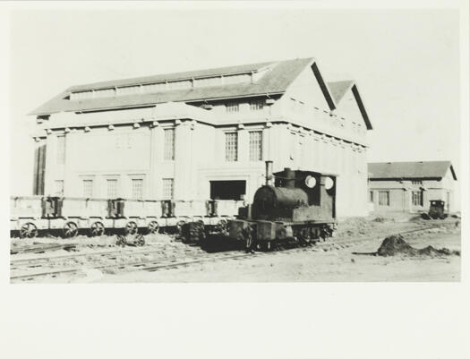 Power House, Kingston showing a locomotive and some coal trucks on the railway line.