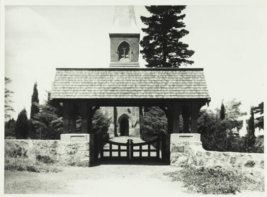 A front view of the lych gate and St John's Church beyond. 